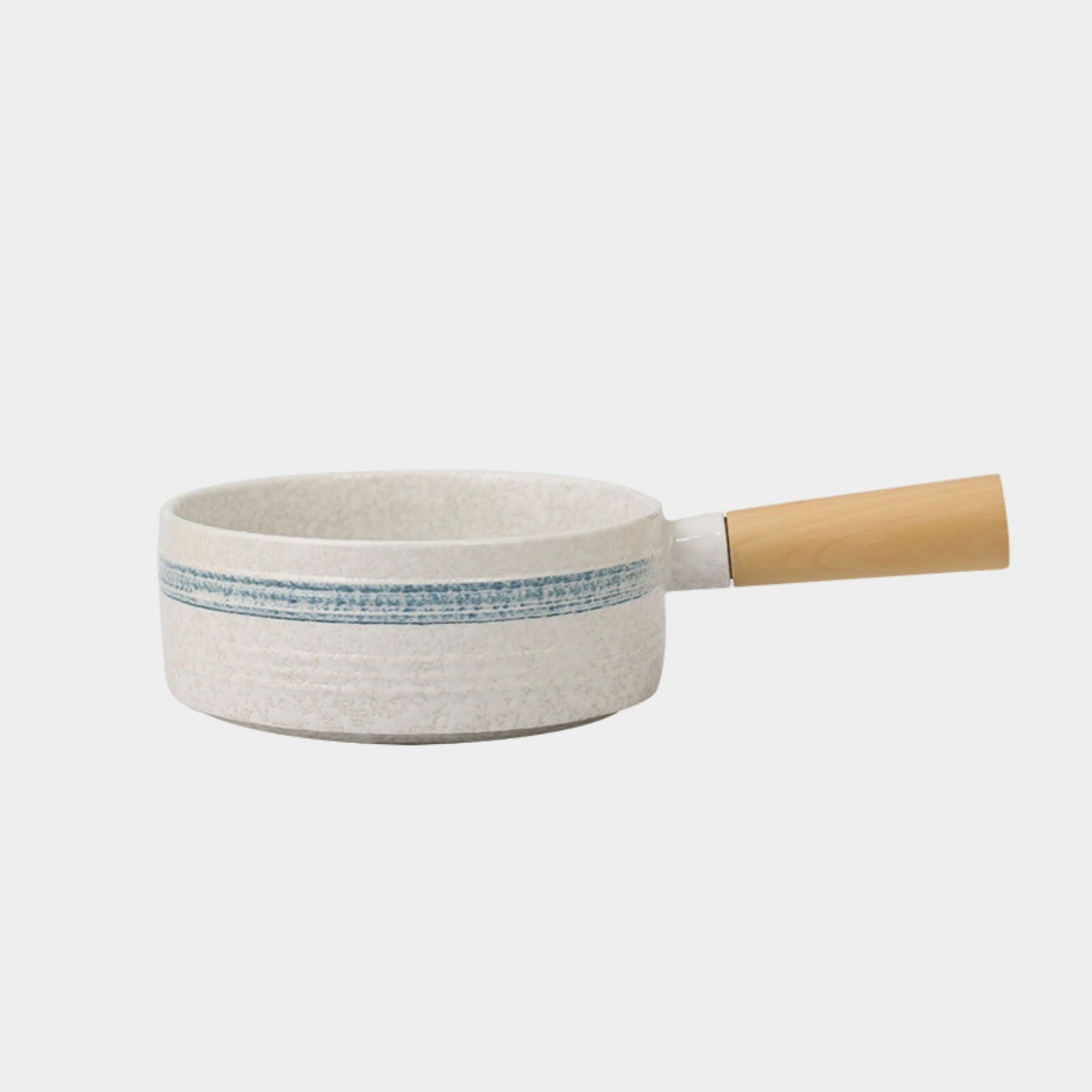 Rustic Japanese stoneware baking plate with blue accents and wooden handle.